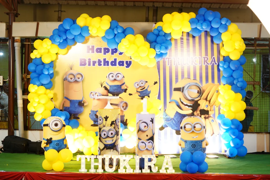 First birthday party decoration with balloon arch, themed backdrop, and cake table setup by Joyful Knots Events in Erode