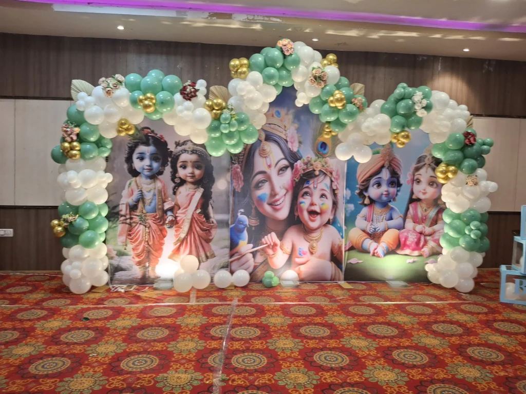Elegant baby shower decoration with floral backdrop, balloon setup, stage décor, cradle arrangement, and family celebration by Joyful Knots Events