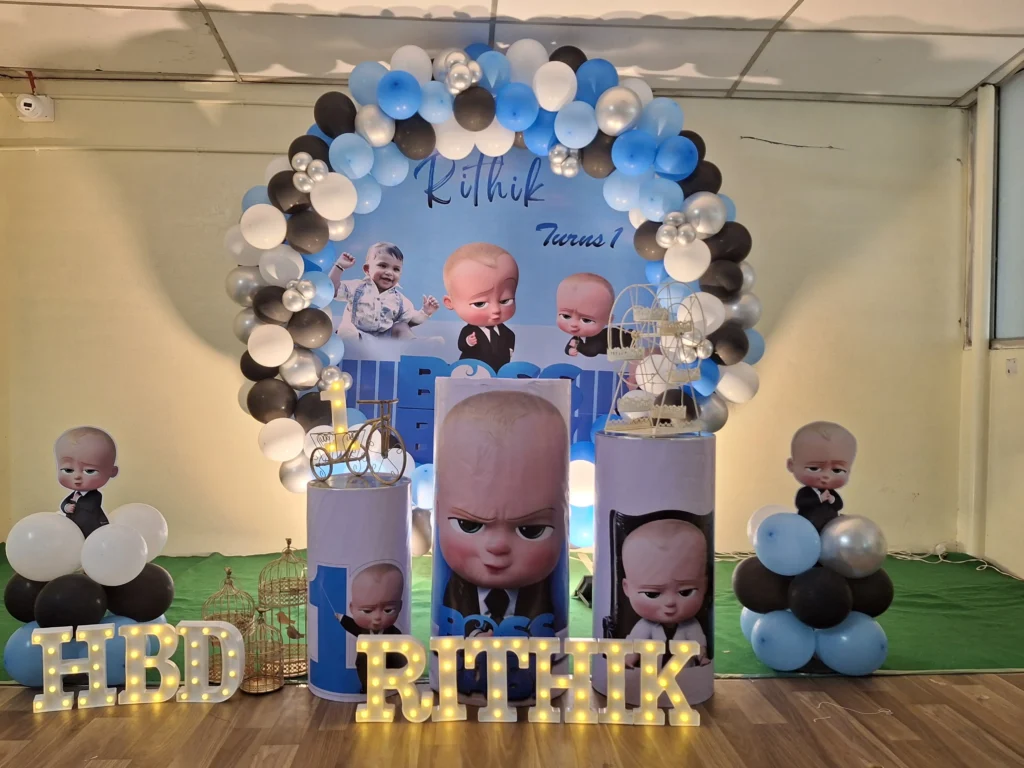 Boss Baby birthday decoration with themed backdrop, balloon arch, stage setup, cake table decoration, and kids party celebration by Joyful Knots Events