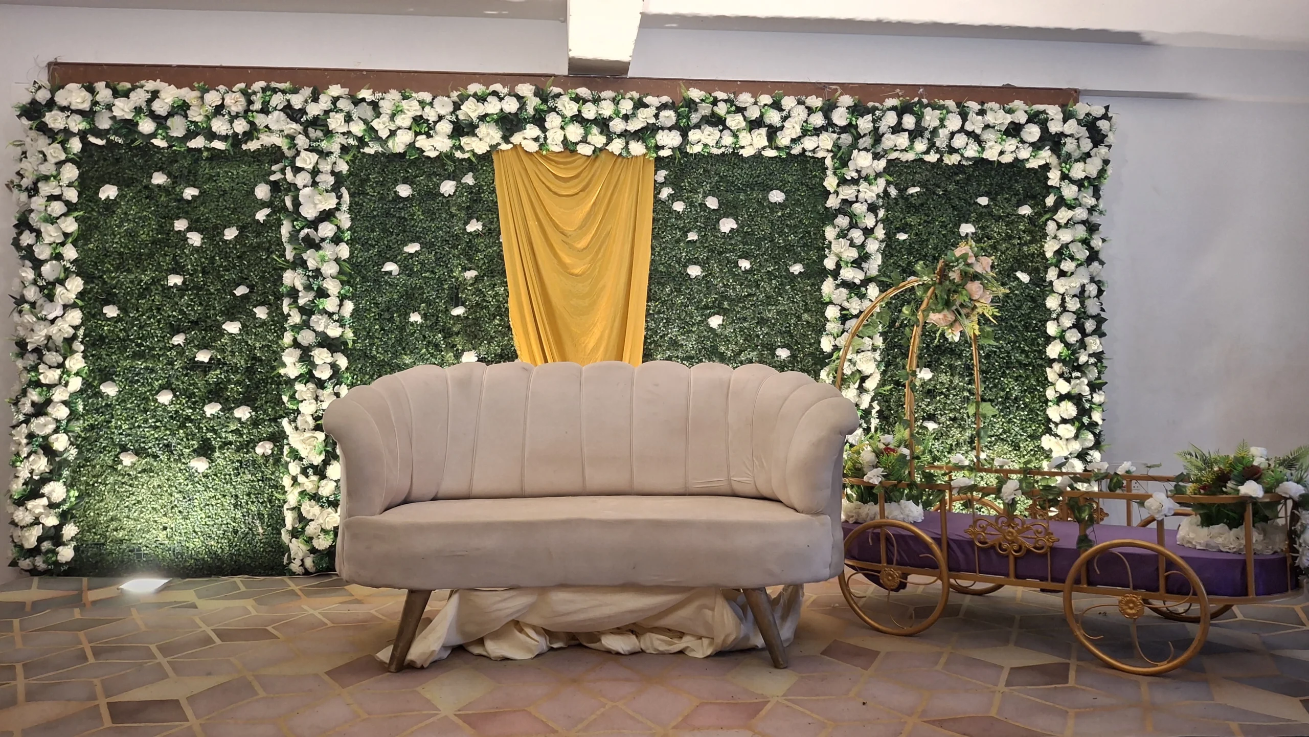 Beautiful name revealing ceremony setup with cradle decoration, floral backdrop, balloon décor, stage arrangement, and family celebration by Joyful Knots Events